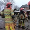 Spuitgasten in actie bij een woningbrand